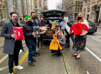 Team members holding Jackets for the Forgotten Children's Fund